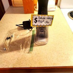 Portable rechargeable waterpik, never used.